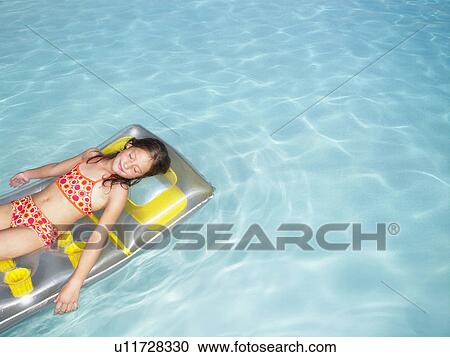 Girl on air mattress in pool. View Large Photo Image Stock Image - Girl on air mattress in pool.. Fotosearch