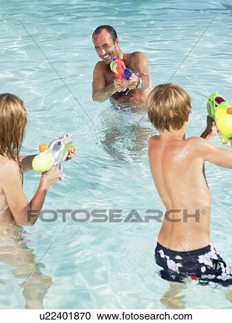 Kids and adult playing with water guns. View Large Photo Image Stock Image - Kids and adult playing with water guns.. Fotosearch