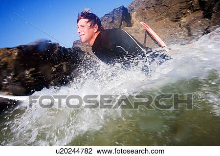 Man on surfboard in splashing water. View Large Photo Image Stock Image - Man on surfboard in splashing water.. Fotosearch