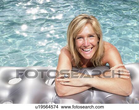 Woman on air mattress in pool. View Large Photo Image Picture - Woman on air mattress in pool.. Fotosearch