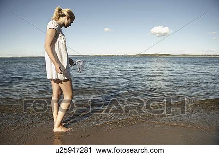 Stock Image - Young woman at beach.. Fotosearch