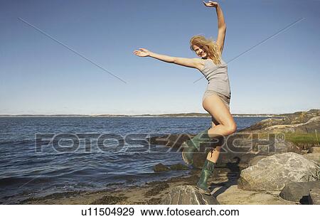 Stock Photo - Young Woman in Wellingtons.. Fotosearch