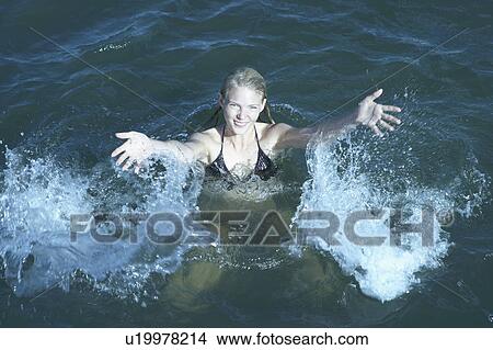 Young Woman Swimming in the Sea. View Large Photo Image Picture - Young Woman Swimming in the Sea.. Fotosearch