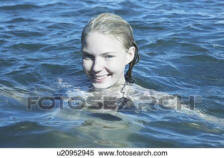 Stock Photography - Young Woman Swimming in the Sea.. Fotosearch