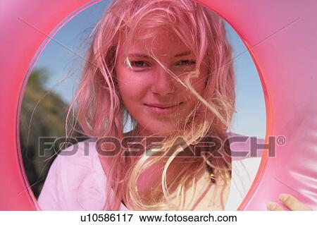 Stock Photo - Young woman with swimming ring. . Fotosearch