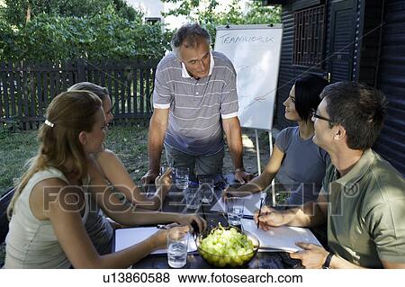 Stock Photo - Businesspeople at a rural retreat.. Fotosearch
