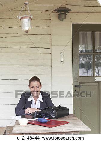 Businesswoman by country cottage View Large Photo Image Picture - Businesswoman by country cottage. Fotosearch