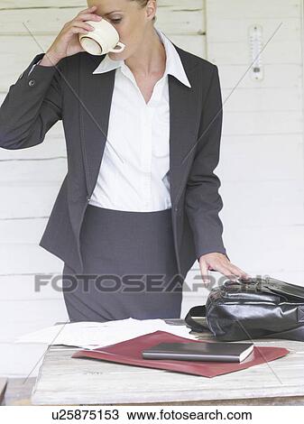 Businesswoman by country cottage drinking coffee View Large Photo Image Stock Image - Businesswoman by country cottage drinking coffee. Fotosearch