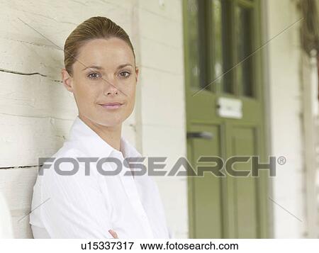 Businesswoman by country cottage View Large Photo Image Stock Photo - Businesswoman by country cottage. Fotosearch