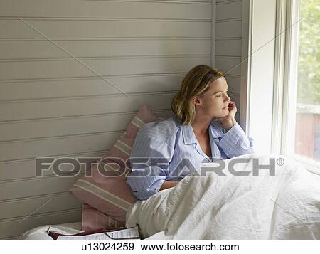 Businesswoman resting with work on bed View Large Photo Image Stock Photo - Businesswoman resting with work on bed. Fotosearch