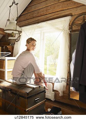 Businesswoman sitting on trunk in home office View Large Photo Image Stock Photography - Businesswoman sitting on trunk in home office. Fotosearch