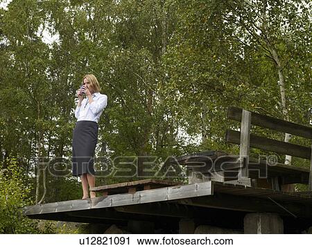 Businesswoman standing on deck View Large Photo Image Stock Image - Businesswoman standing on deck. Fotosearch