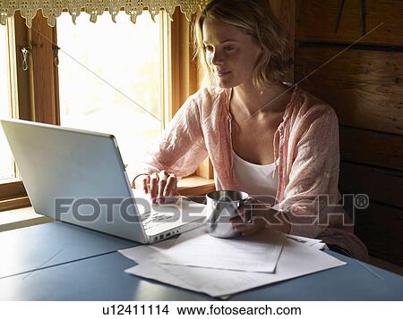 Picture - Businesswoman working from home. Fotosearch