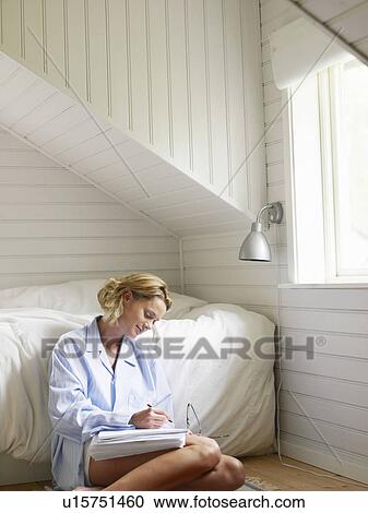 Stock Image - Businesswoman working from home. Fotosearch