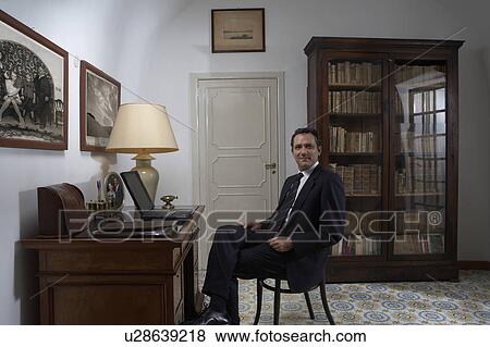 Man using laptop in home office, portrait View Large Photo Image Stock Photo - Man using laptop in home office, portrait. Fotosearch