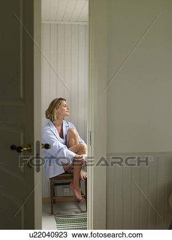 Woman on chair looking upwards View Large Photo Image Stock Image - Woman on chair looking upwards. Fotosearch