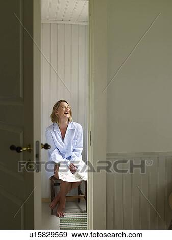 Woman on chair with a newspaper View Large Photo Image Stock Photo - Woman on chair with a newspaper. Fotosearch