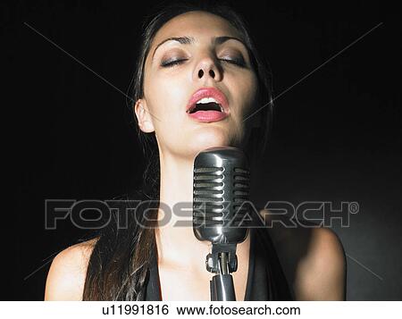 Female singer with microphone elegant black dress portrait. View Large Photo Image Stock Photograph - Female singer with microphone elegant black dress portrait.. Fotosearch