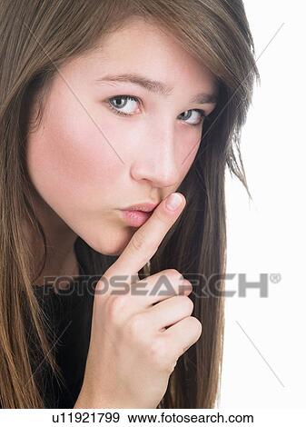 Stock Photo - Girl with finger in front of her mouth. Fotosearch