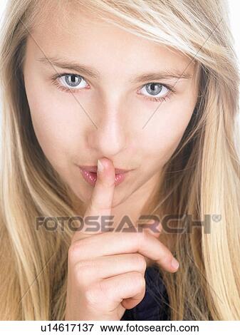 Girl with finger in front of her mouth View Large Photo Image Stock Photo - Girl with finger in front of her mouth. Fotosearch