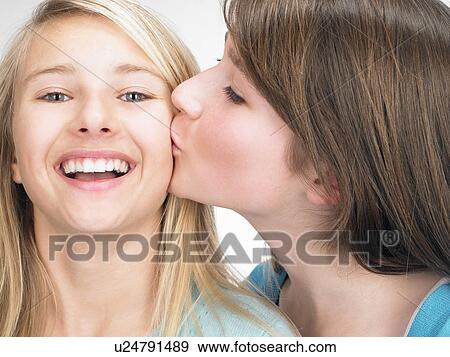 Sisters cheek-kissing View Large Photo Image Stock Photo - Sisters cheek-kissing. Fotosearch