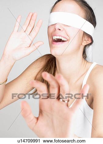 Woman blindfolded, smiling View Large Photo Image Stock Image - Woman blindfolded, smiling. Fotosearch