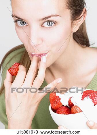 Woman eating strawberries View Large Photo Image Stock Image - Woman eating strawberries. Fotosearch