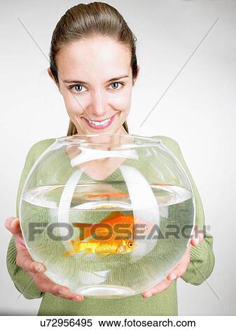 Woman handing a goldfish aquarium View Large Photo Image Stock Photography - Woman handing a goldfish aquarium. Fotosearch