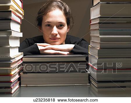Stock Photo - Woman resting on books. Fotosearch