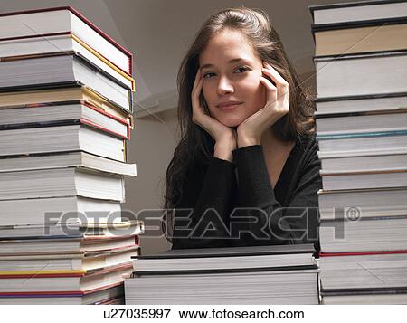 Woman resting on books View Large Photo Image Stock Photo - Woman resting on books. Fotosearch