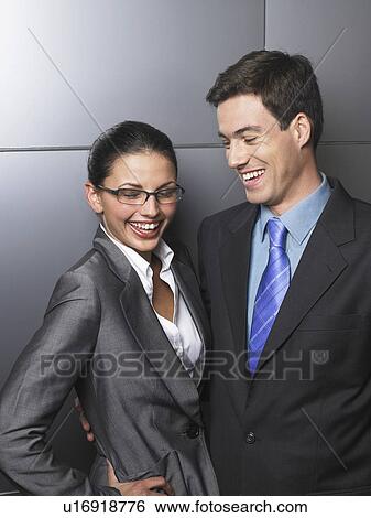 Businessman and businesswoman standing together View Large Photo Image Stock Photograph - Businessman and businesswoman standing together. Fotosearch