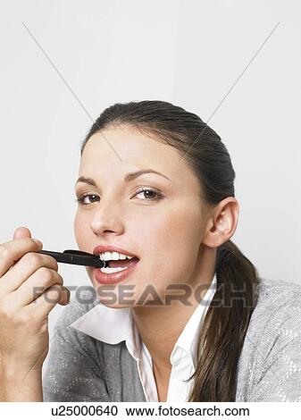 Stock Image - Businesswoman at her desk. Fotosearch