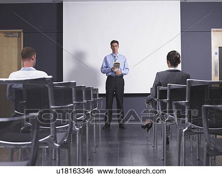 Man giving speech in presentation room View Large Photo Image Stock Photograph - Man giving speech in presentation room. Fotosearch
