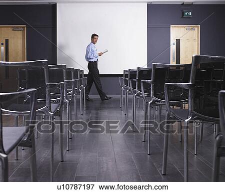 Man practicing speech in empty presentation room View Large Photo Image Stock Photo - Man practicing speech in empty presentation room. Fotosearch