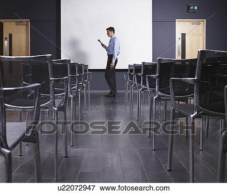 Man practicing speech in empty presentation room View Large Photo Image Stock Photo - Man practicing speech in empty presentation room. Fotosearch