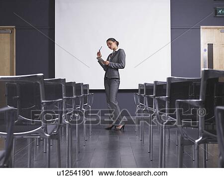 Woman practicing speech in empty presentation room View Large Photo Image Stock Image - Woman practicing speech in empty presentation room. Fotosearch