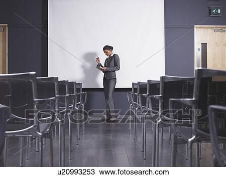 Woman practicing speech in empty presentation room View Large Photo Image Stock Image - Woman practicing speech in empty presentation room. Fotosearch