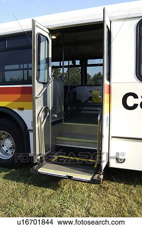 Image of a lift on an accessible bus that will lift a wheel chair onto the bus. View Large Photo Image Picture - Image of a lift on an accessible bus that will lift a wheel chair onto the bus.. Fotosearch