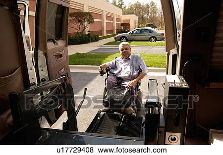 Man with a disability utilizing a powered wheelchair for mobility, preparing to enter his accessible van via a lift for wheelchairs/scooters. View Large Photo Image Stock Photo - Man with a disability utilizing a powered wheelchair for mobility, preparing to enter his accessible van via a lift for wheelchairs/scooters.. Fotosearch