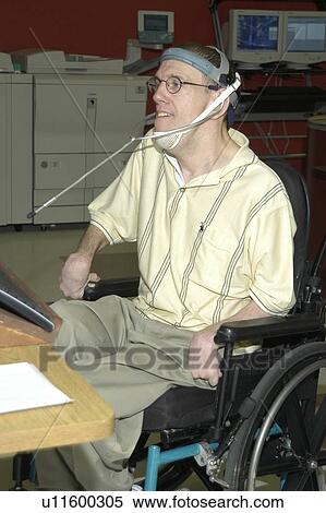 Man with significant disabilities utilizing headgear to operate communications apparatus. View Large Photo Image Stock Photography - Man with significant disabilities utilizing headgear to operate communications apparatus.. Fotosearch