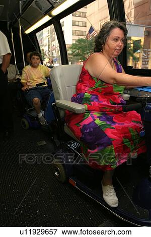 Woman using a scooter/cart for mobility riding a city bus. View Large Photo Image Stock Photo - Woman using a scooter/cart for mobility riding a city bus.. Fotosearch