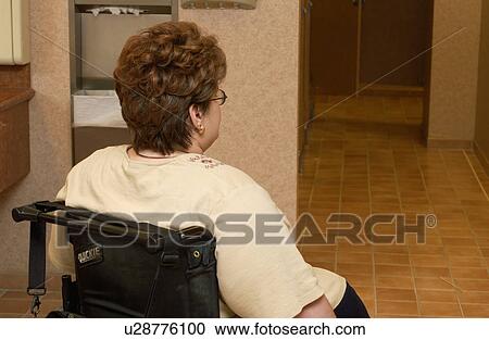 Woman with a disability utilizing a wheelchair for mobility, entering the bathroom and heading to the accessible stall. View Large Photo Image Stock Image - Woman with a disability utilizing a wheelchair for mobility, entering the bathroom and heading to the accessible stall.. Fotosearch