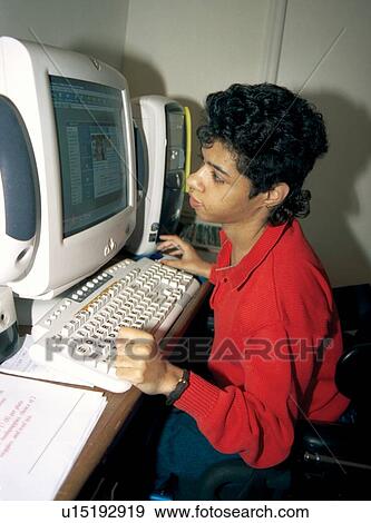 Stock Photo - Woman with multiple disabilities signing on to the internet with her computer to chat with her friends.. Fotosearch