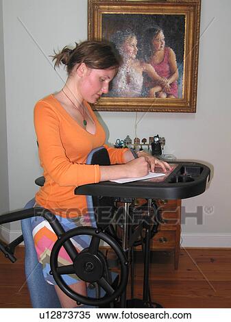 Young woman writes a note while exercising her tendons on a “stander. ” View Large Photo Image Stock Photography - Young woman writes a note while exercising her tendons on a “stander. ”. Fotosearch