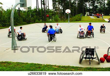 A group of men playing a game of wheelchair basketball at their local recreation center. View Large Photo Image Stock Photo - A group of men playing a game of wheelchair basketball at their local recreation center.. Fotosearch