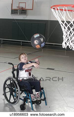 Action shot of a boy in a wheelchair playing basketball. View Large Photo Image Stock Image - Action shot of a boy in a wheelchair playing basketball.. Fotosearch