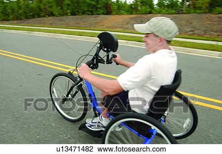 Boy with disabilities, typically utilizing a wheelchair for mobility, riding a bicycle/tricycle adapted to be powered by hand controls. View Large Photo Image Stock Image - Boy with disabilities, typically utilizing a wheelchair for mobility, riding a bicycle/tricycle adapted to be powered by hand controls.. Fotosearch
