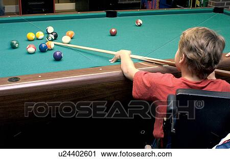 Cute boy, using a wheelchair for mobility, being a sharp shooter at one of his favorite games - pool! View Large Photo Image Stock Image - Cute boy, using a wheelchair for mobility, being a sharp shooter at one of his favorite games - pool!. Fotosearch