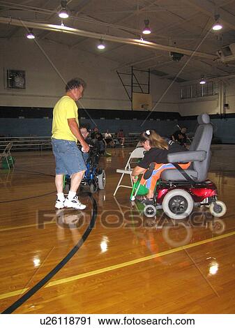 Girl, in wheelchair, in a gym, with man. View Large Photo Image Stock Image - Girl, in wheelchair, in a gym, with man.. Fotosearch