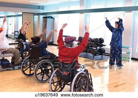 Group of people with disabilities, all utilizing wheelchairs or scooters for mobility, participating in an aerobics/fitness class. View Large Photo Image Stock Photo - Group of people with disabilities, all utilizing wheelchairs or scooters for mobility, participating in an aerobics/fitness class.. Fotosearch